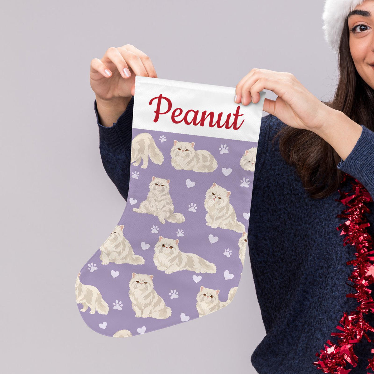 Persian Christmas stocking on soft lavender background with example name Peanut in red script on the white cuff; view 5.