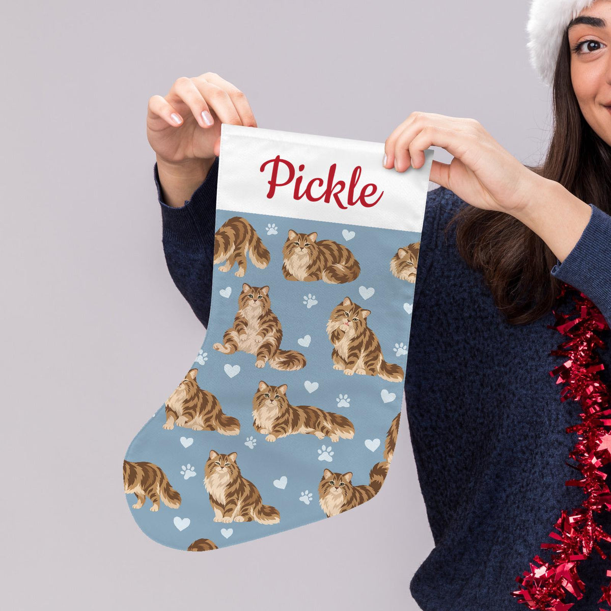 Siberian Christmas stocking on dusty blue background with example name Pickle in red script on the white cuff; view 5.