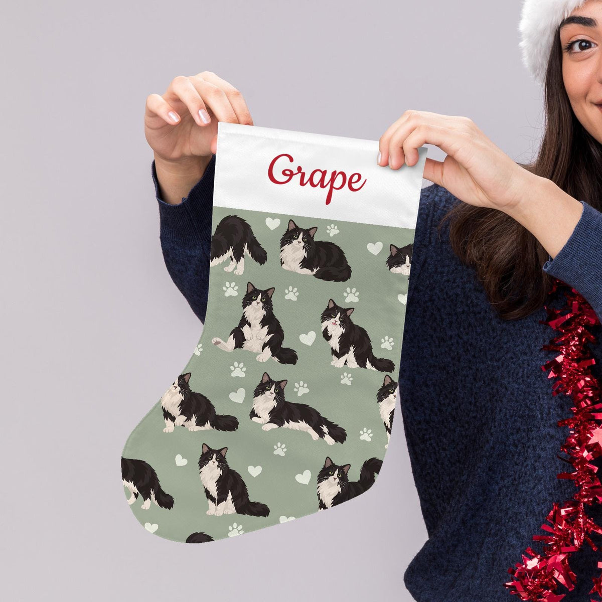 Domestic Longhair Christmas stocking on soft sage background with example name Grape in red script on the white cuff; view 5.