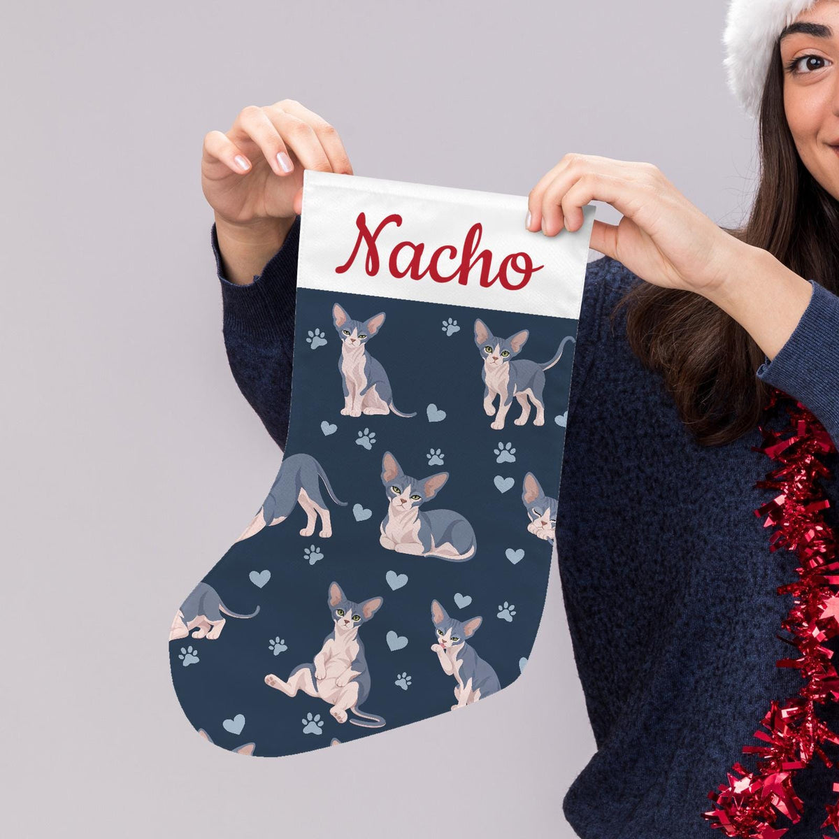 Sphynx Blue and white skin pigmentation Christmas stocking on deep navy background with example name Nacho in red script on the white cuff; view 5.