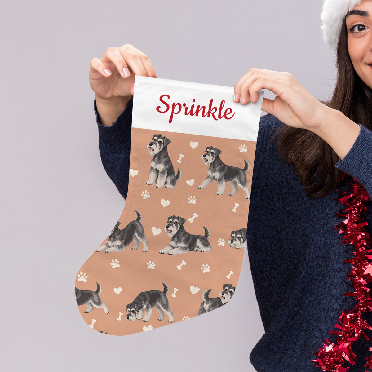 Miniature Schnauzer Christmas stocking on peach background with example name Sprinkle in red script on the white cuff; view 4.