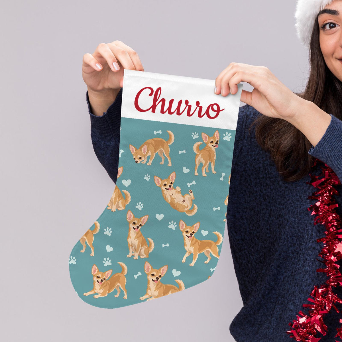Chihuahua Christmas stocking on muted teal background with example name Churro in red script on the white cuff; view 5.