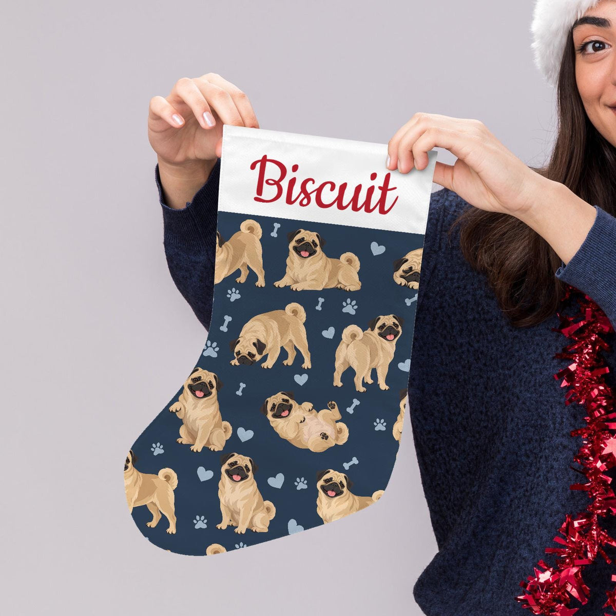 Pug Christmas stocking on deep navy background with example name Biscuit in red script on the white cuff; view 5.