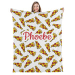 A woman is holding up a blanket with a repeating pattern of pizza slices on it.