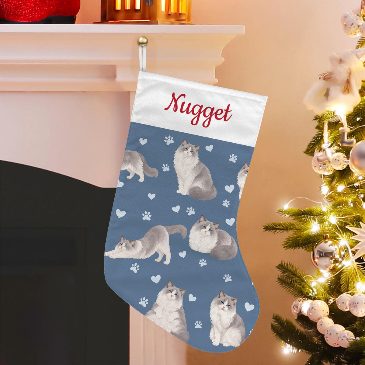 Ragdoll Christmas stocking on slate blue background with example name Nugget in red script on the white cuff; view 1.