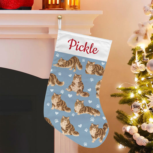 Siberian Christmas stocking on dusty blue background with example name Pickle in red script on the white cuff; view 1.