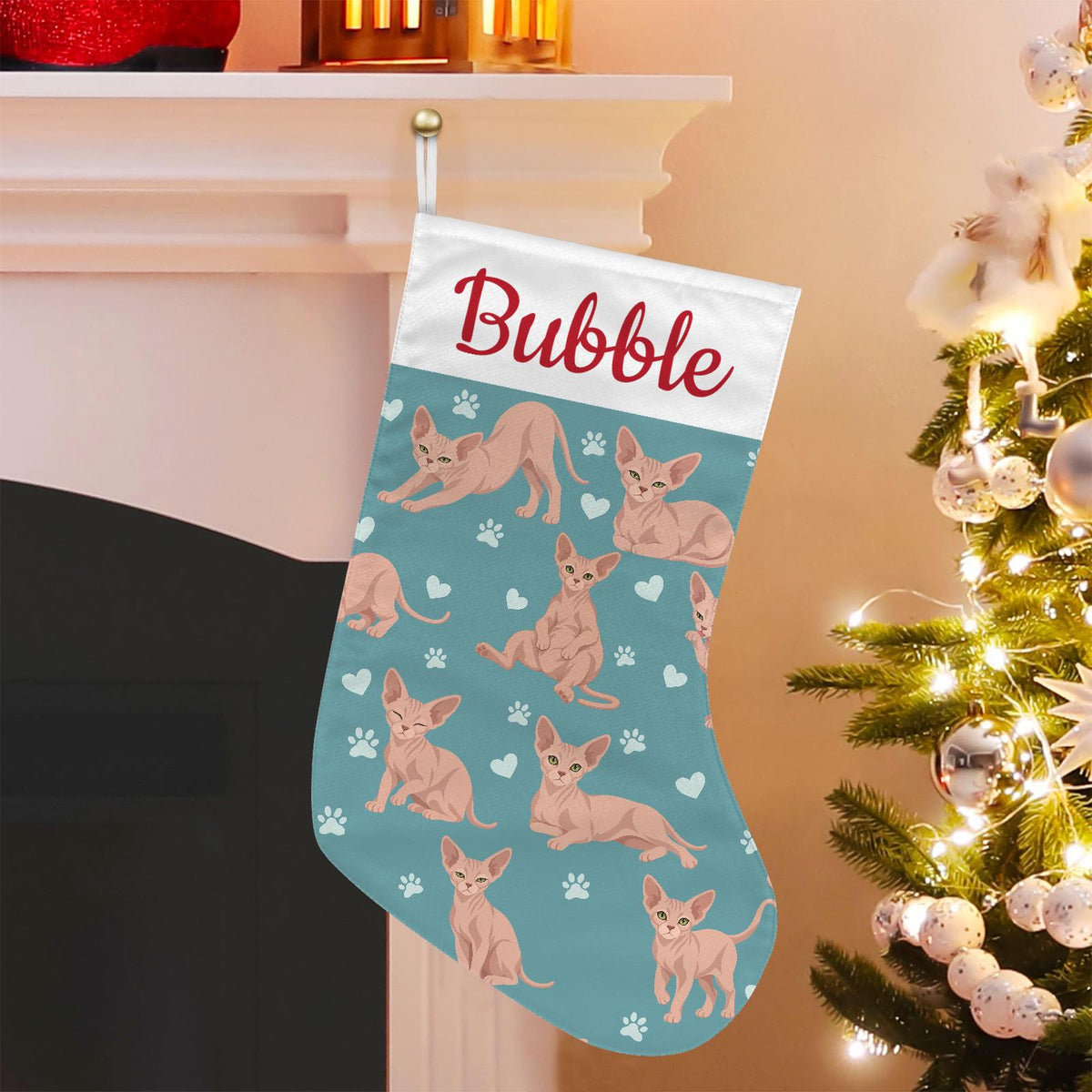 Sphynx Christmas stocking on muted teal background with example name Bubble in red script on the white cuff; view 1.