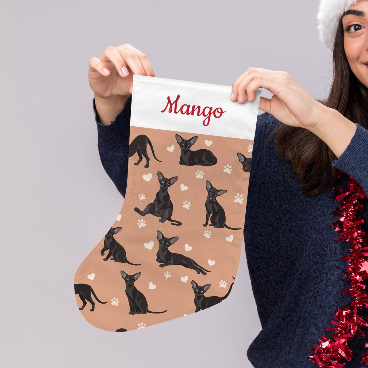 Oriental Christmas stocking on peach background with example name Mango in red script on the white cuff; view 5.