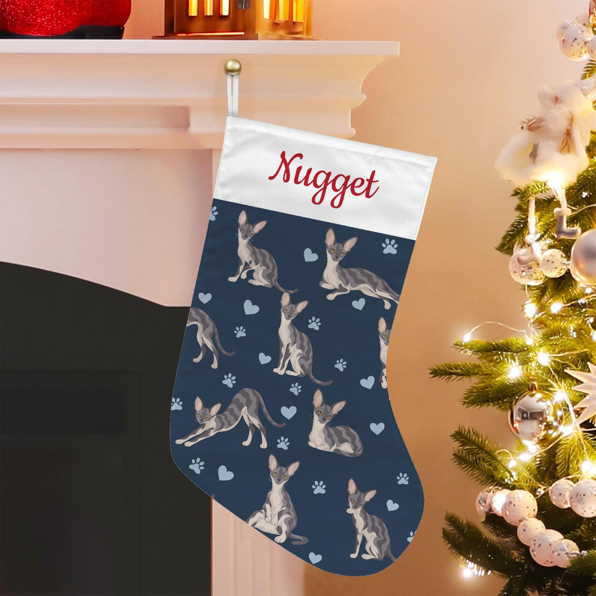 Cornish Rex Christmas stocking on deep navy background with example name Nugget in red script on the white cuff; view 1.