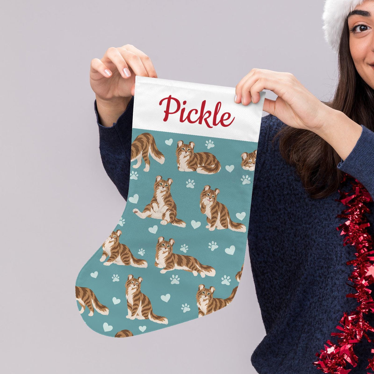 American Curl Christmas stocking on muted teal background with example name Pickle in red script on the white cuff; view 5.