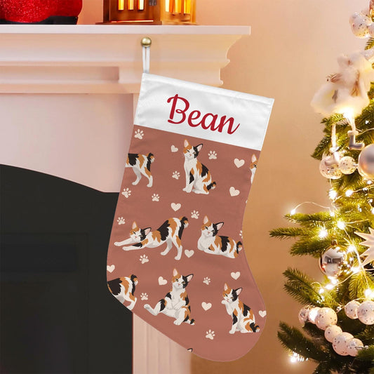 Japanese Bobtail Christmas stocking on muted terracotta background with example name Bean in red script on the white cuff; view 1.