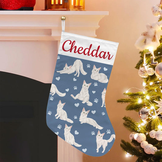 Turkish Angora Christmas stocking on slate blue background with example name Cheddar in red script on the white cuff; view 1.