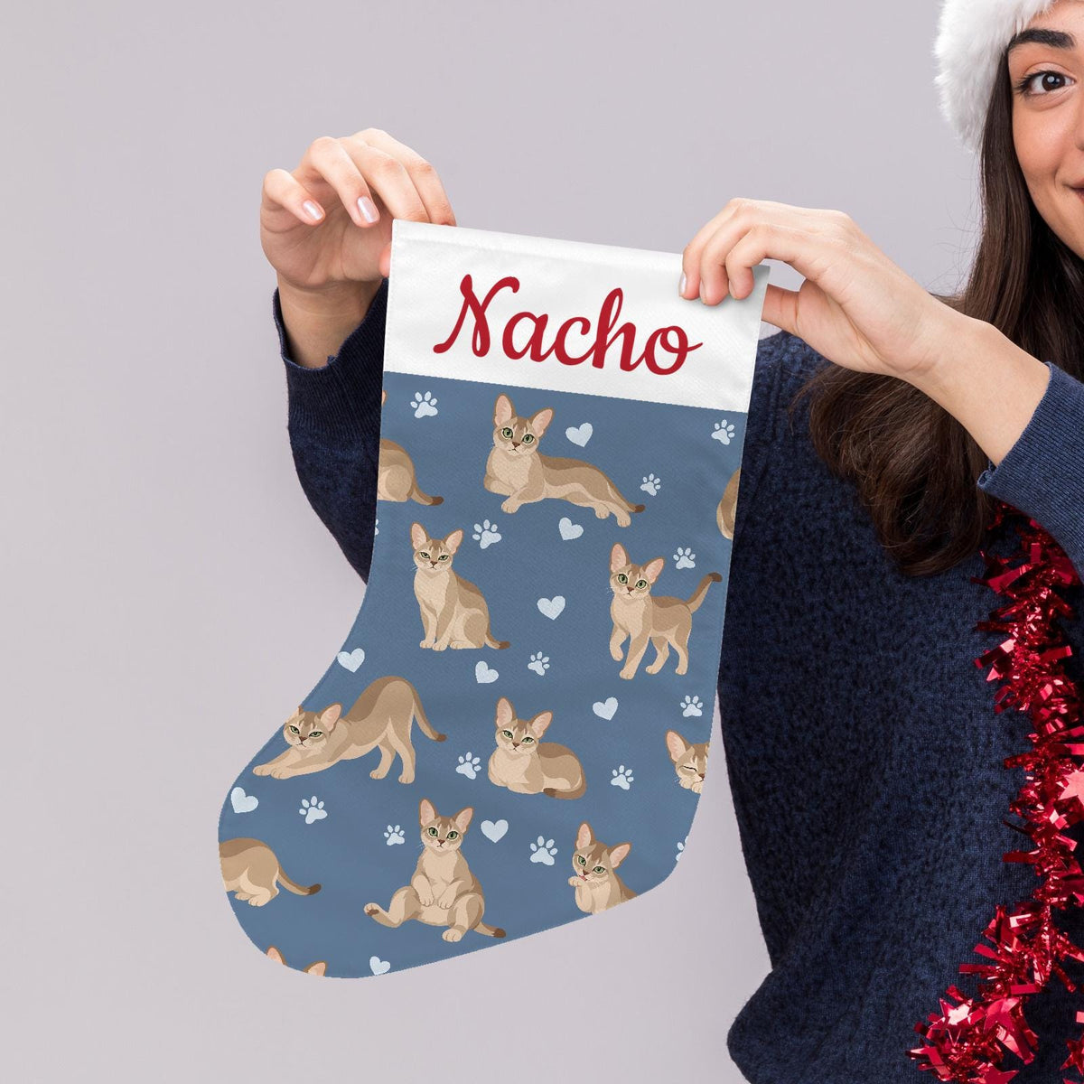 Singapura Christmas stocking on slate blue background with example name Nacho in red script on the white cuff; view 5.