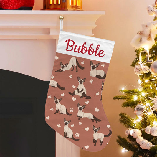 Balinese Christmas stocking on muted terracotta background with example name Bubble in red script on the white cuff; view 1.