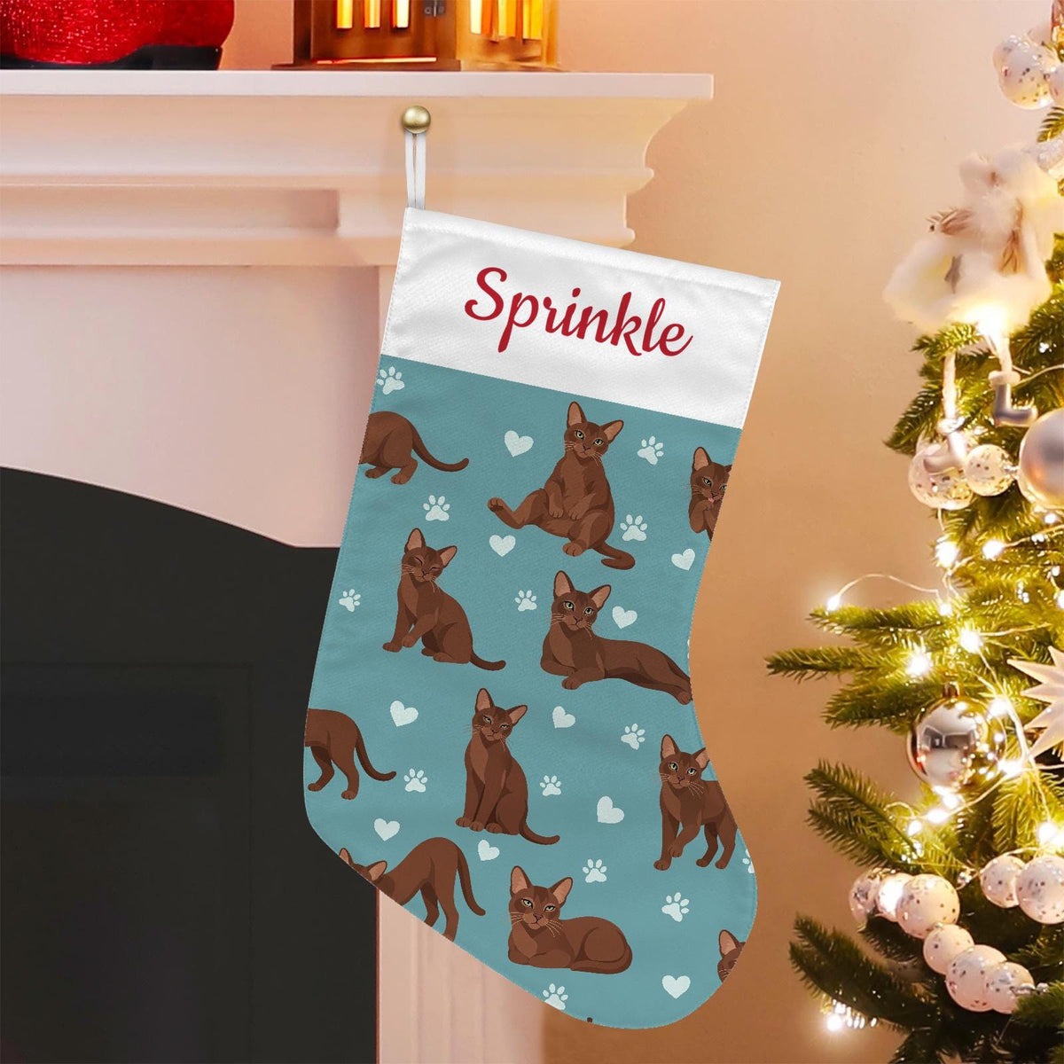 Havana Brown Christmas stocking on muted teal background with example name Sprinkle in red script on the white cuff; view 1.