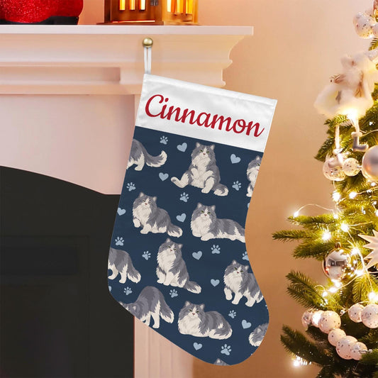 Ragamuffin Christmas stocking on deep navy background with example name Cinnamon in red script on the white cuff; view 1.
