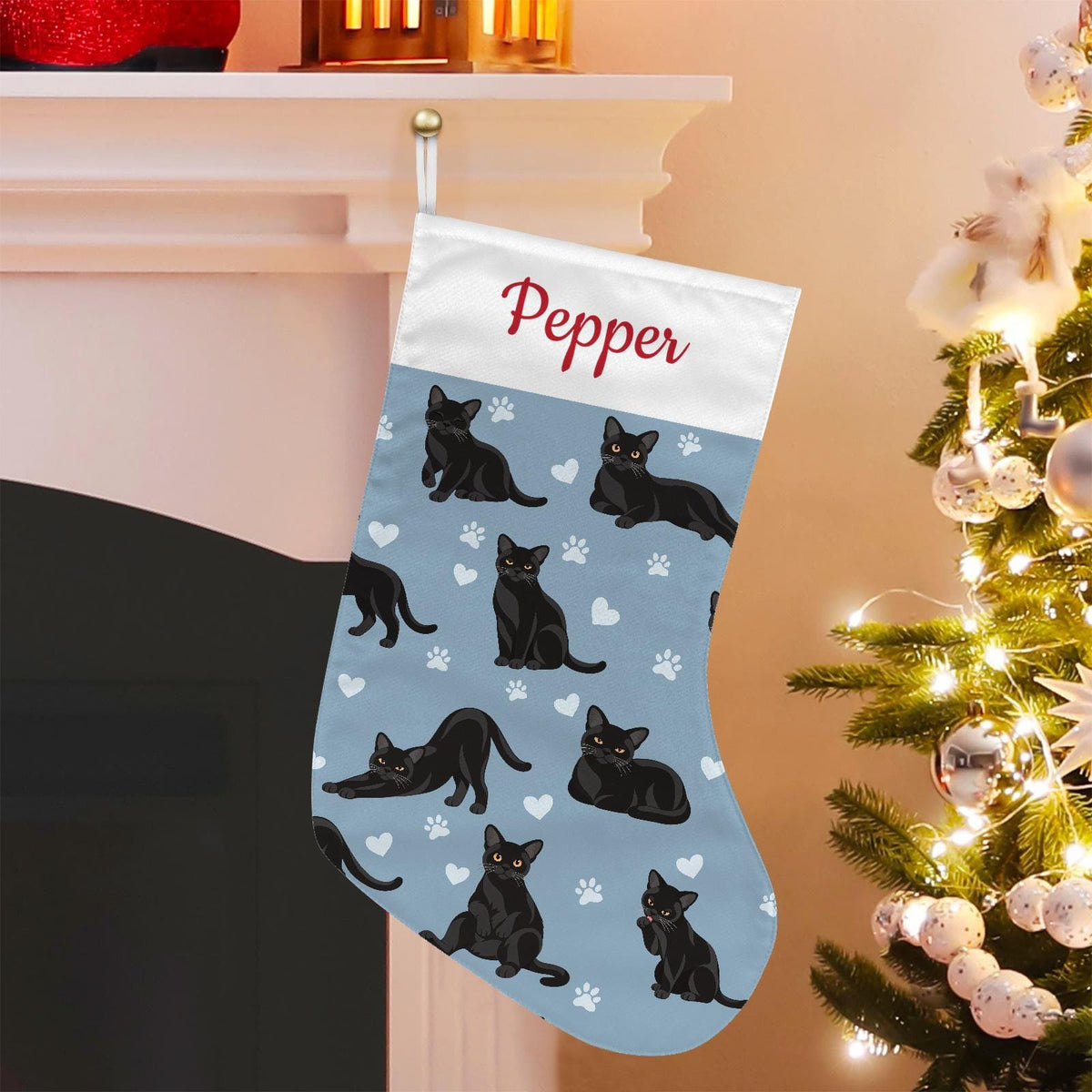 Bombay Christmas stocking on dusty blue background with example name Pepper in red script on the white cuff; view 1.