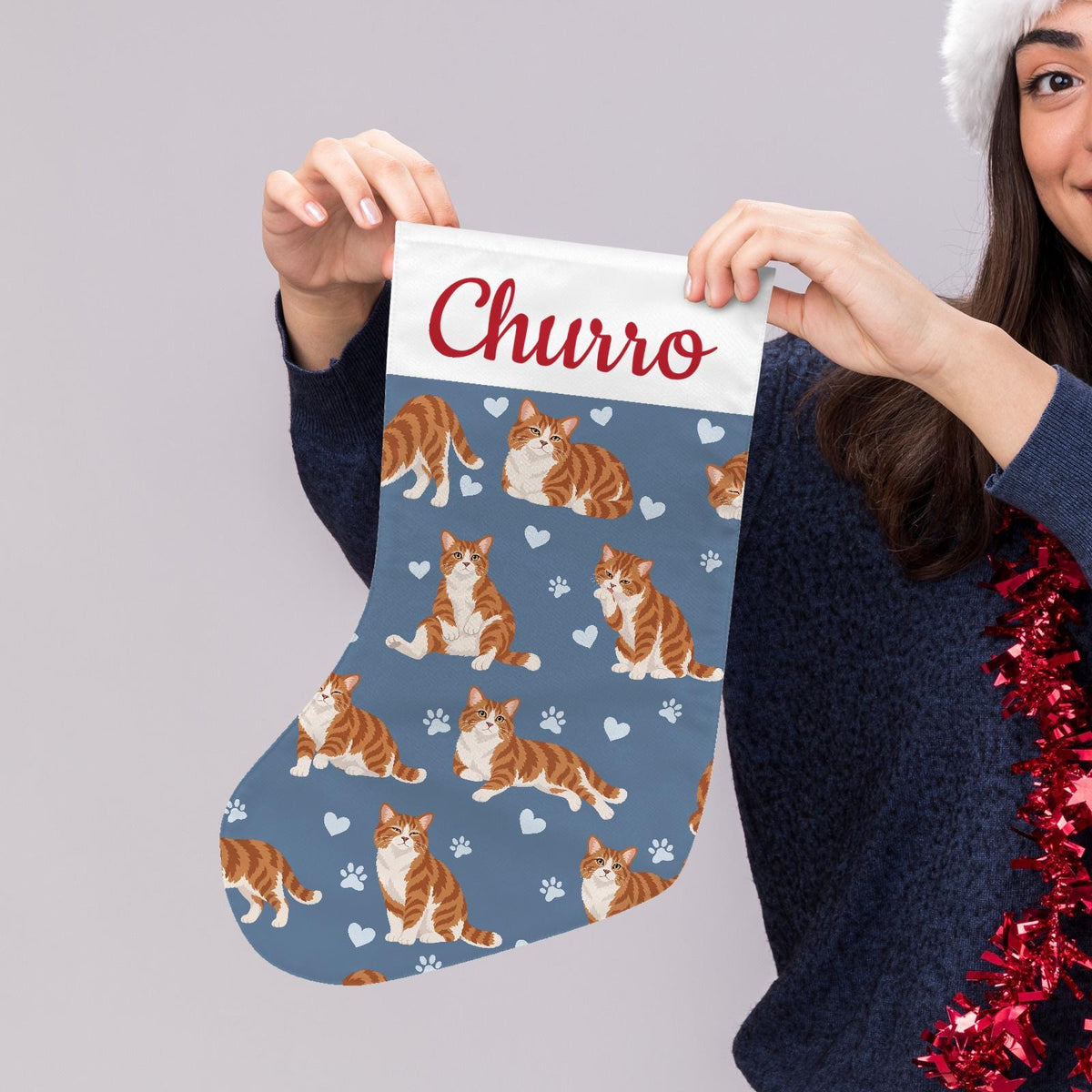 American Wirehair Christmas stocking on slate blue background with example name Churro in red script on the white cuff; view 5.