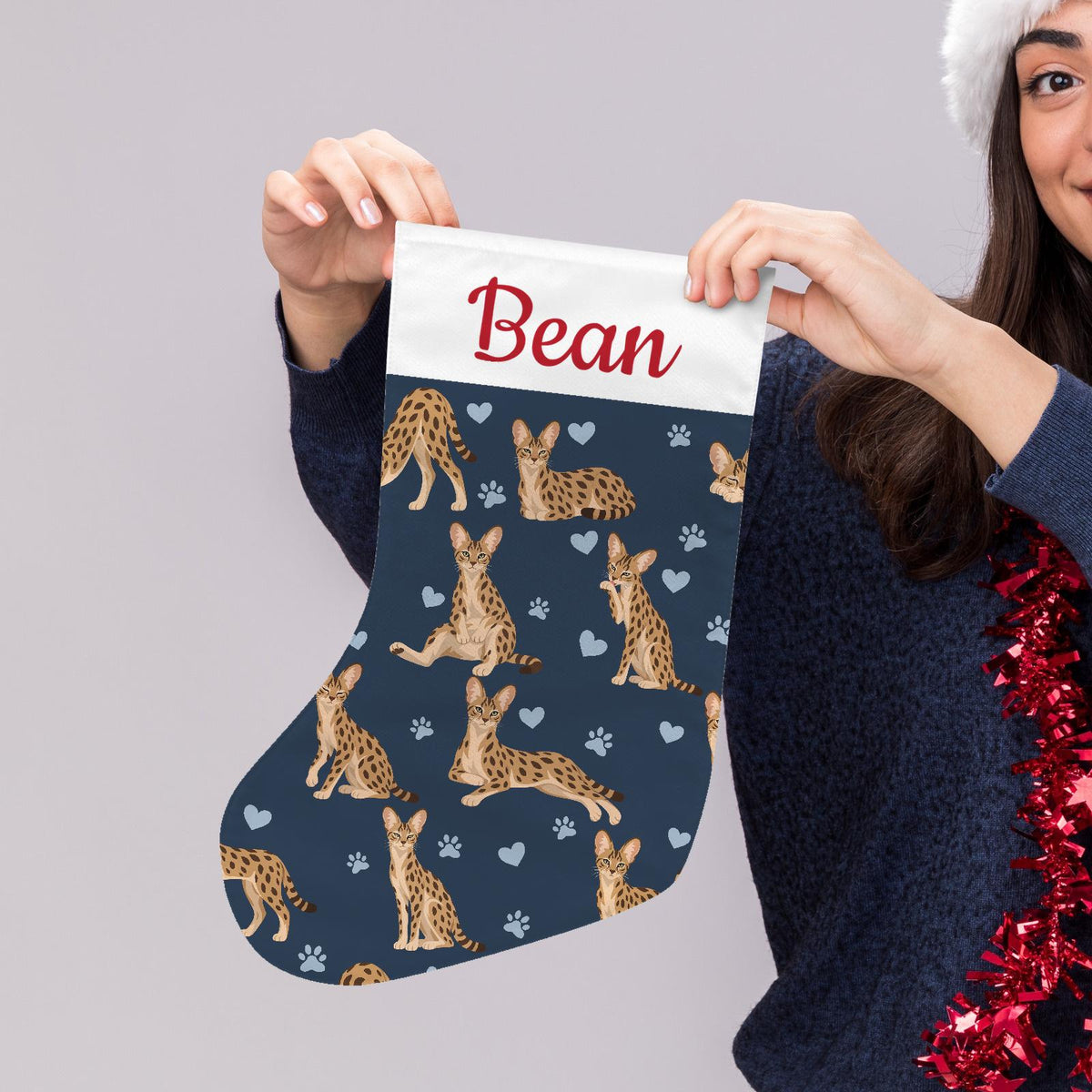 Savannah Christmas stocking on deep navy background with example name Bean in red script on the white cuff; view 5.