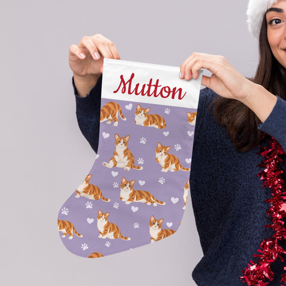 Munchkin Christmas stocking on soft lavender background with example name Mutton in red script on the white cuff; view 5.