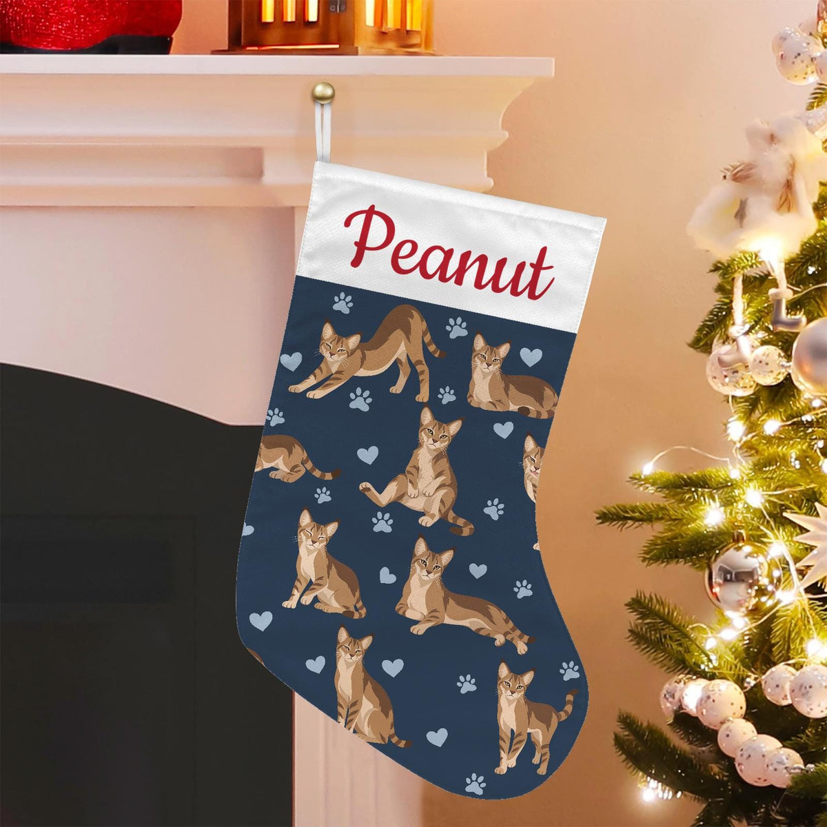 Chausie Christmas stocking on deep navy background with example name Peanut in red script on the white cuff; view 1.