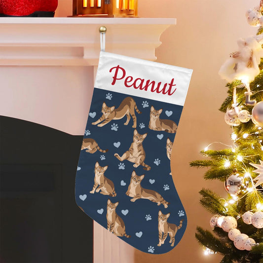 Chausie Christmas stocking on deep navy background with example name Peanut in red script on the white cuff; view 1.