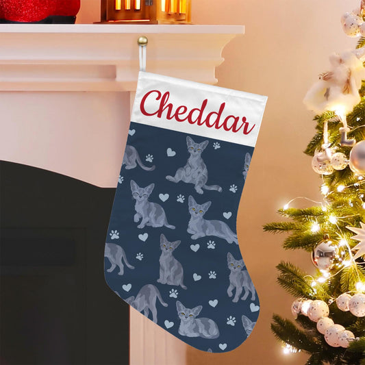 Devon Rex Blue Christmas stocking on deep navy background with example name Cheddar in red script on the white cuff; view 1.