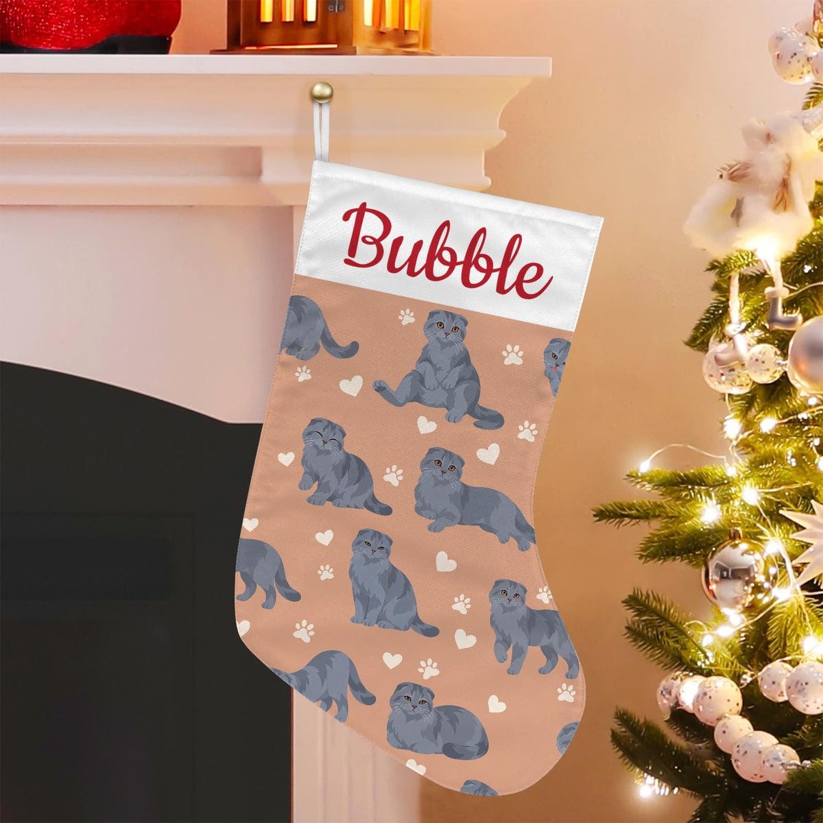 Scottish Fold Solid blue gray Christmas stocking on peach background with example name Bubble in red script on the white cuff; view 1.