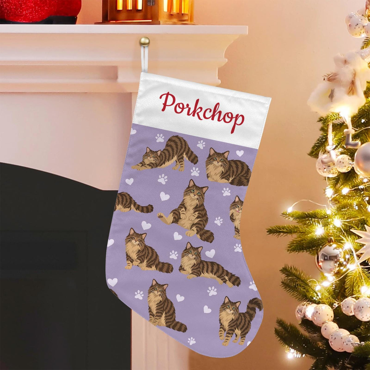 Domestic Longhair Brown mackerel tabby Christmas stocking on soft lavender background with example name Porkchop in red script on the white cuff; view 1.