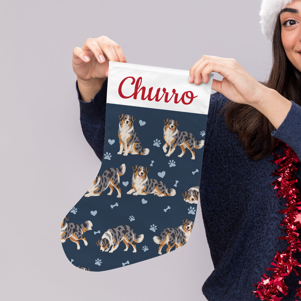 Australian Shepherd Christmas stocking on deep navy background with example name Churro in red script on the white cuff; view 4.