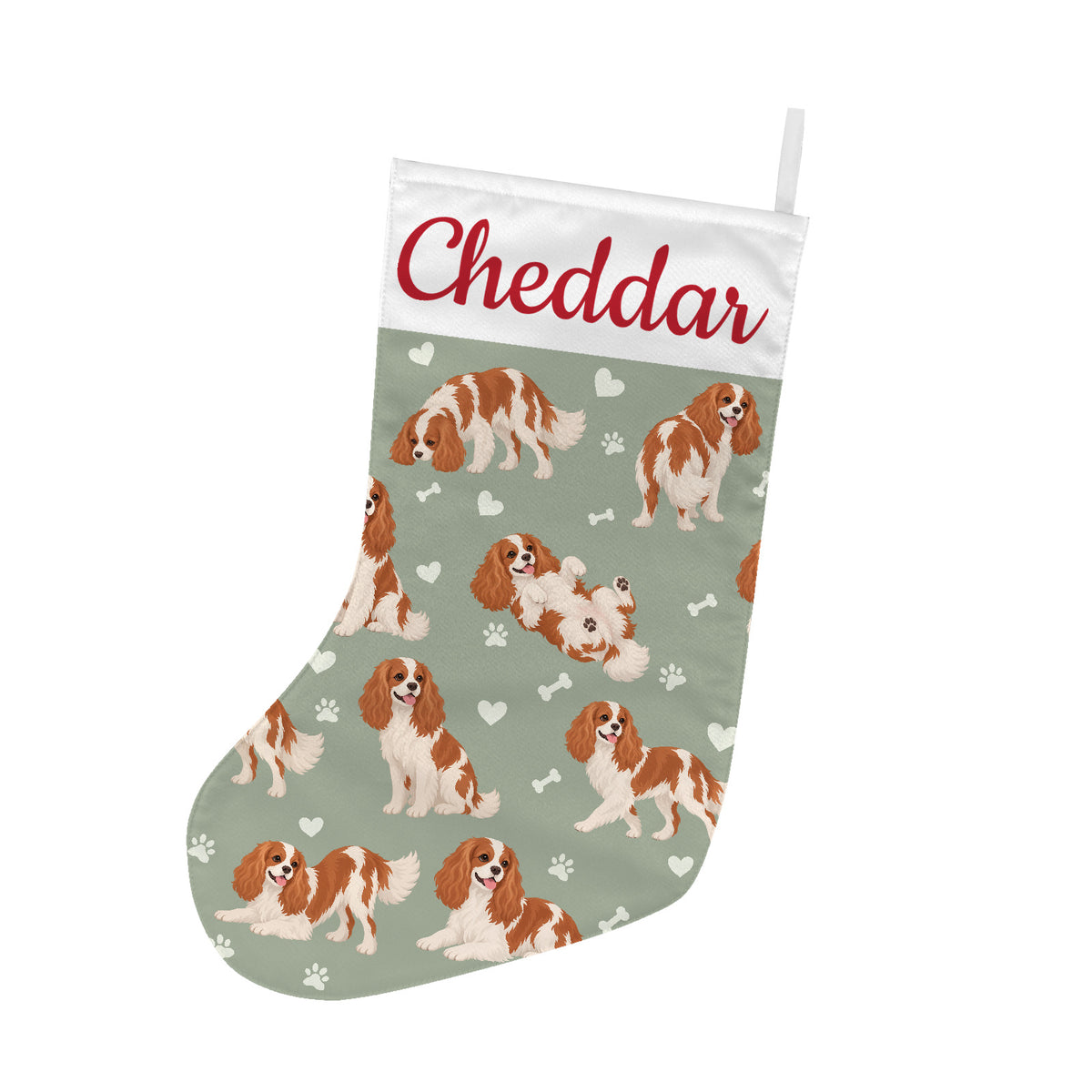 Cavalier King Charles Spaniel Christmas stocking on soft sage background with example name Cheddar in red script on the white cuff; view 1.