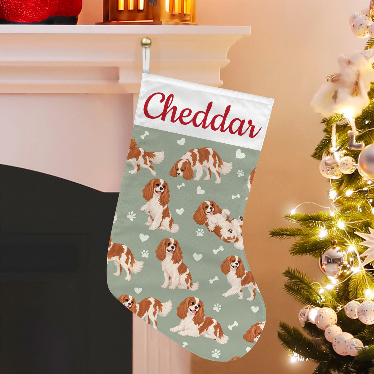 Cavalier King Charles Spaniel Christmas stocking on soft sage background with example name Cheddar in red script on the white cuff; view 5.