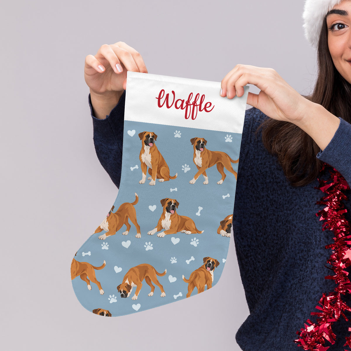 Boxer Christmas stocking on dusty blue background with example name Waffle in red script on the white cuff; view 4.