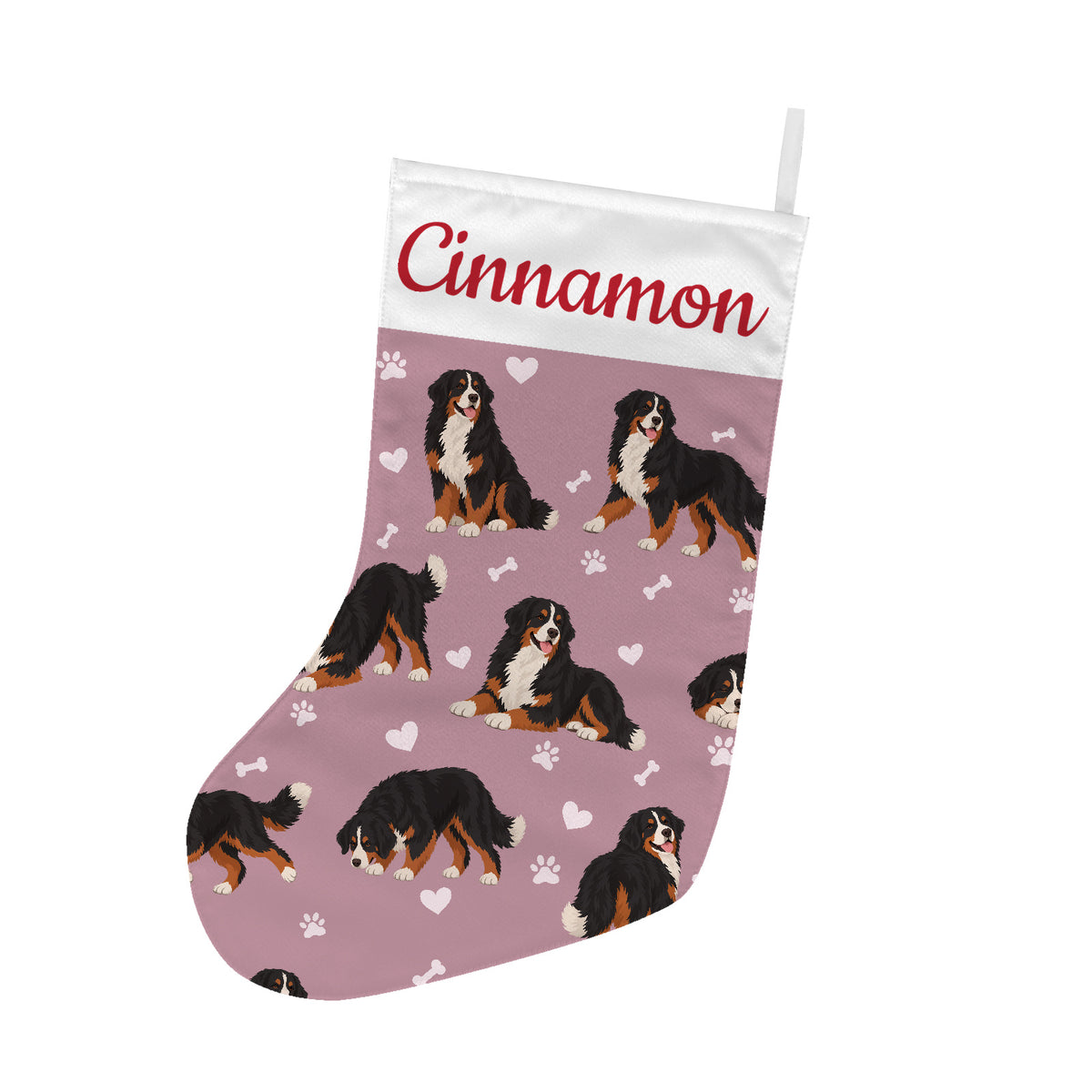 Bernese Mountain Dog Christmas stocking on dusty rose background with example name Cinnamon in red script on the white cuff; view 1.