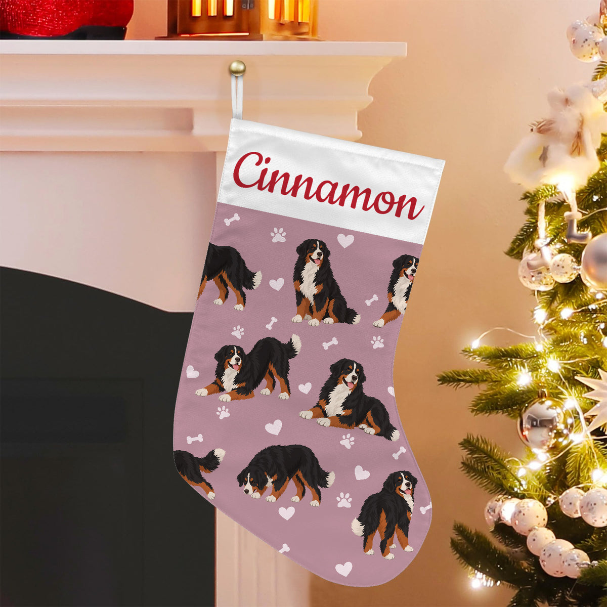 Bernese Mountain Dog Christmas stocking on dusty rose background with example name Cinnamon in red script on the white cuff; view 5.