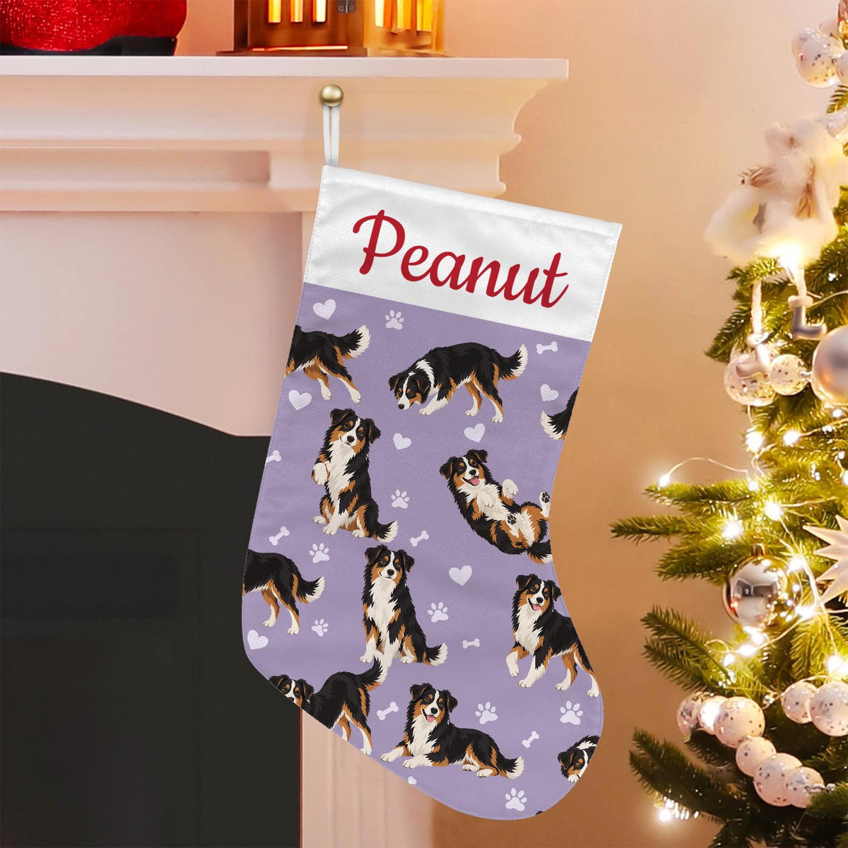 Miniature American Shepherd Christmas stocking on soft lavender background with example name Peanut in red script on the white cuff; view 1.