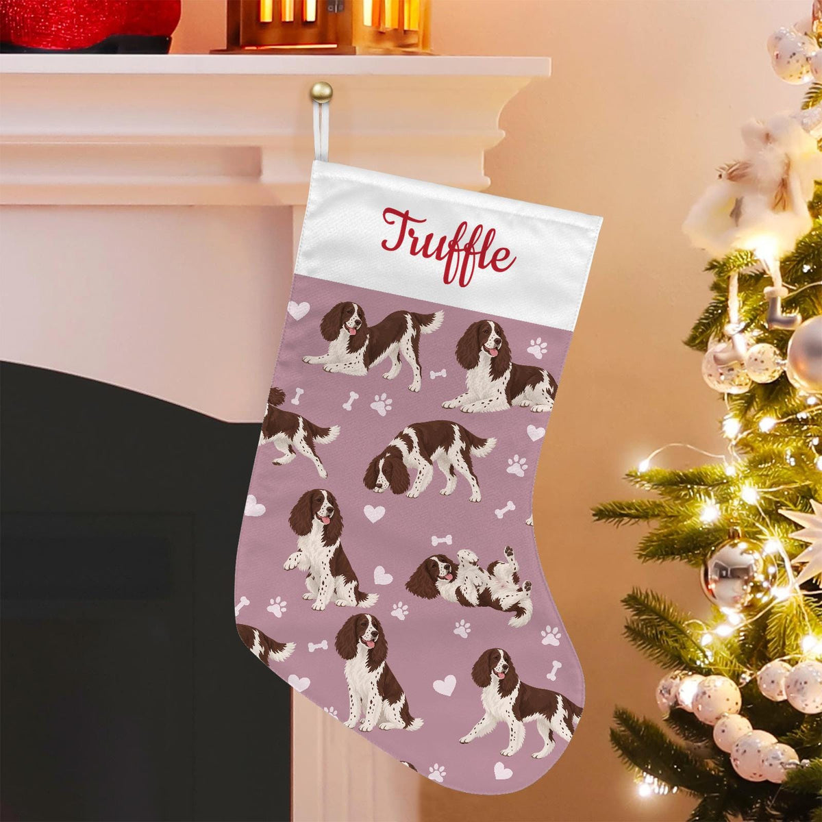 English Springer Spaniel Christmas stocking on dusty rose background with example name Truffle in red script on the white cuff; view 1.