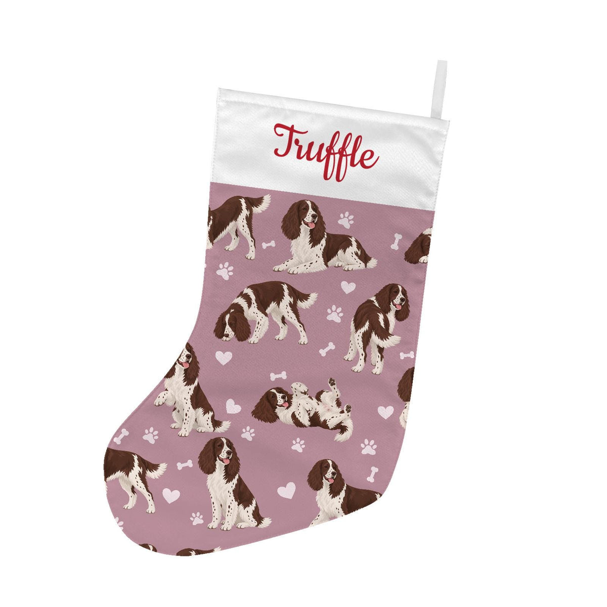 English Springer Spaniel Christmas stocking on dusty rose background with example name Truffle in red script on the white cuff; view 2.