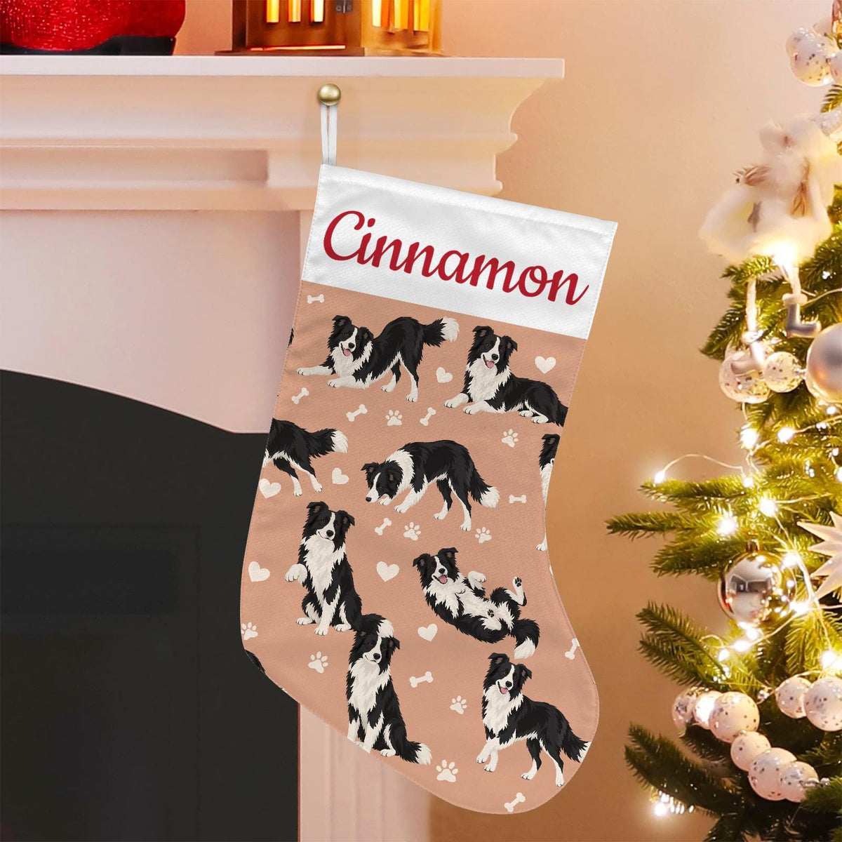 Border Collie Christmas stocking on peach background with example name Cinnamon in red script on the white cuff; view 1.