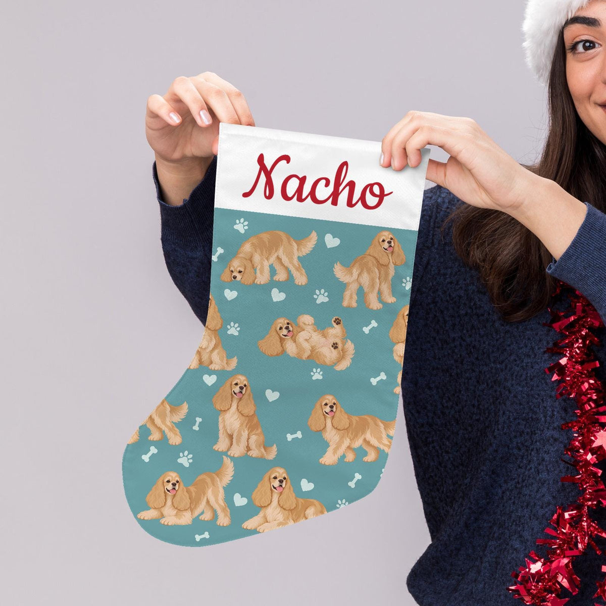 Cocker Spaniel Christmas stocking on muted teal background with example name Nacho in red script on the white cuff; view 5.