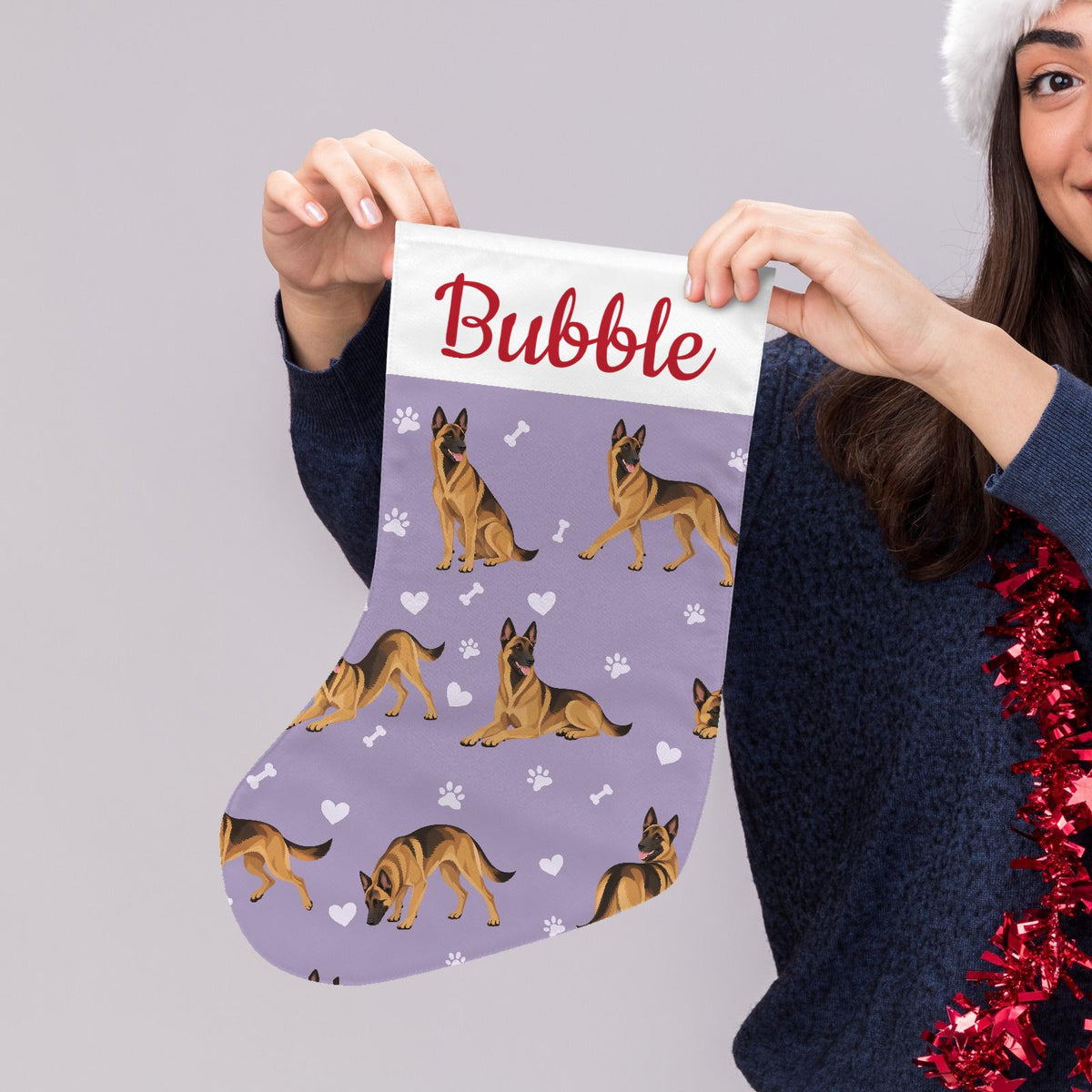 Belgian Malinois Christmas stocking on soft lavender background with example name Bubble in red script on the white cuff; view 5.