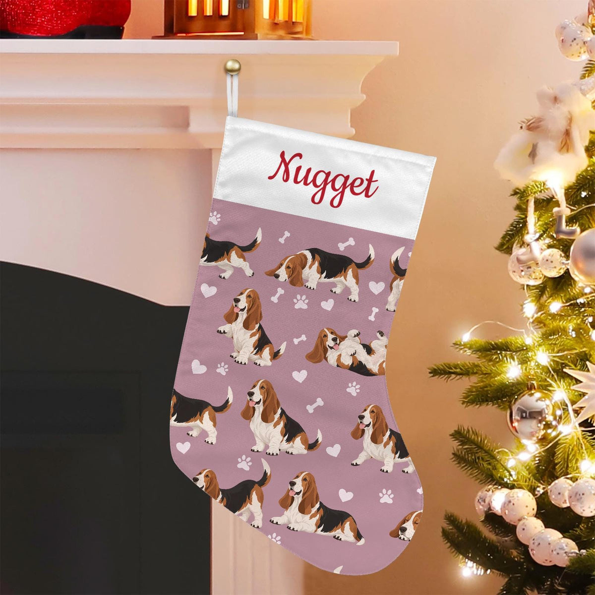 Basset Hound Christmas stocking on dusty rose background with example name Nugget in red script on the white cuff; view 1.