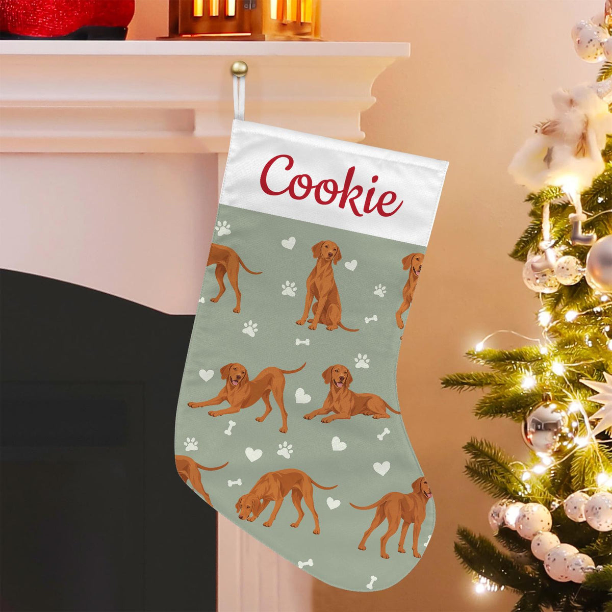 Vizsla Christmas stocking on soft sage background with example name Cookie in red script on the white cuff; view 1.