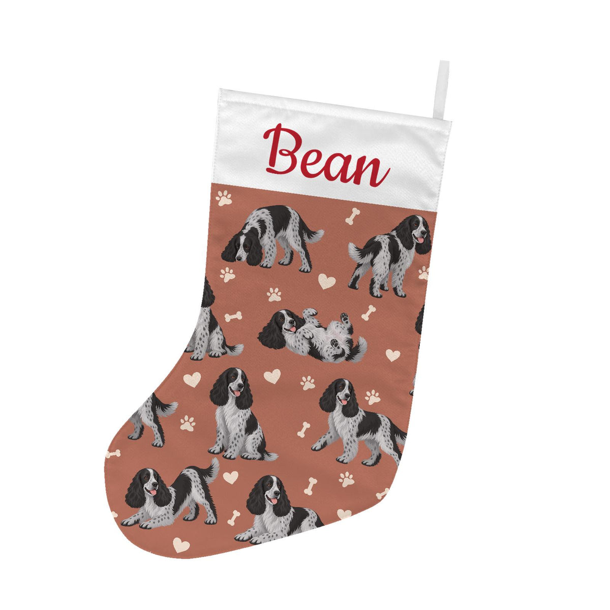 English Cocker Spaniel Christmas stocking on muted terracotta background with example name Bean in red script on the white cuff; view 2.