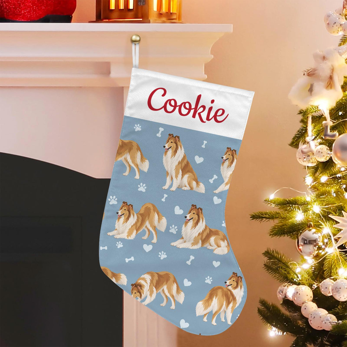 Collie Christmas stocking on dusty blue background with example name Cookie in red script on the white cuff; view 1.