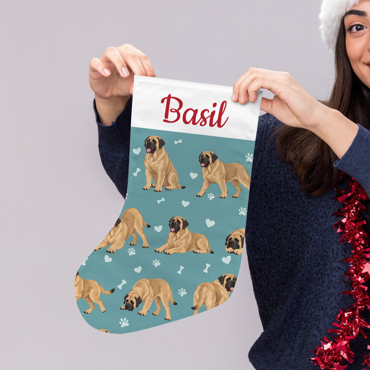 Mastiff Christmas stocking on muted teal background with example name Basil in red script on the white cuff; view 5.