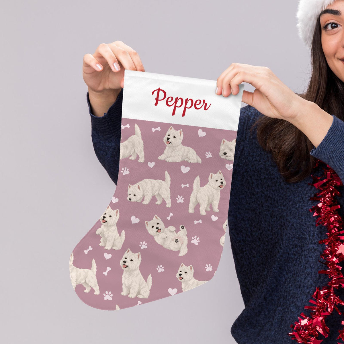 West Highland White Terrier Christmas stocking on dusty rose background with example name Pepper in red script on the white cuff; view 5.
