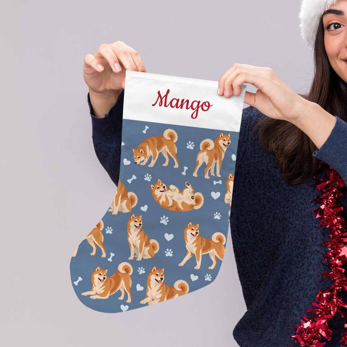Shiba Inu Christmas stocking on slate blue background with example name Mango in red script on the white cuff; view 5.