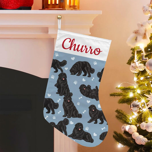 Newfoundland Christmas stocking on dusty blue background with example name Churro in red script on the white cuff; view 1.