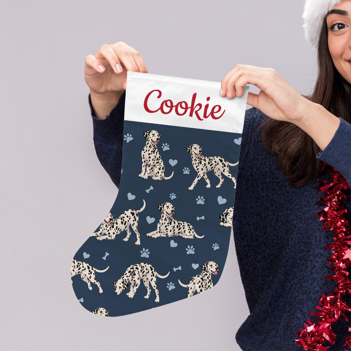 Dalmatian Christmas stocking on deep navy background with example name Cookie in red script on the white cuff; view 5.